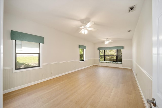 unfurnished room with light wood-type flooring and ceiling fan