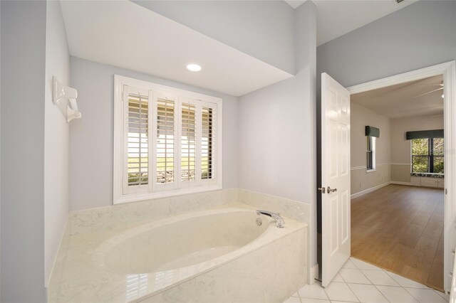 bathroom featuring a bath and hardwood / wood-style floors