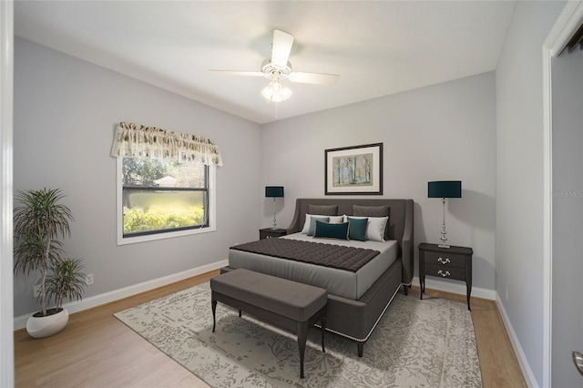 bedroom with ceiling fan and wood-type flooring