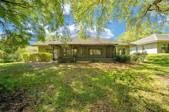 rear view of property featuring a yard