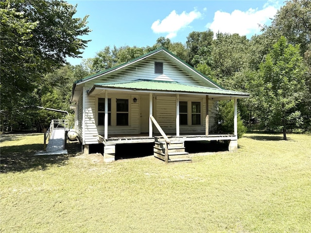 back of property featuring a lawn and a porch