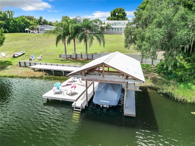 view of dock with a water view and a yard