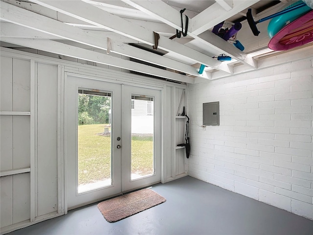 entryway with concrete flooring, electric panel, and french doors