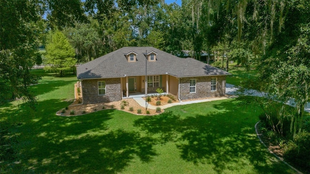 rear view of property featuring a lawn