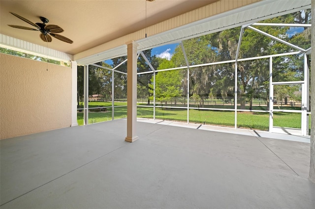 view of patio with ceiling fan and a lanai