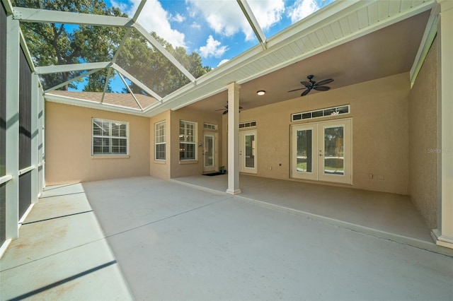 unfurnished sunroom with vaulted ceiling, ceiling fan, and french doors