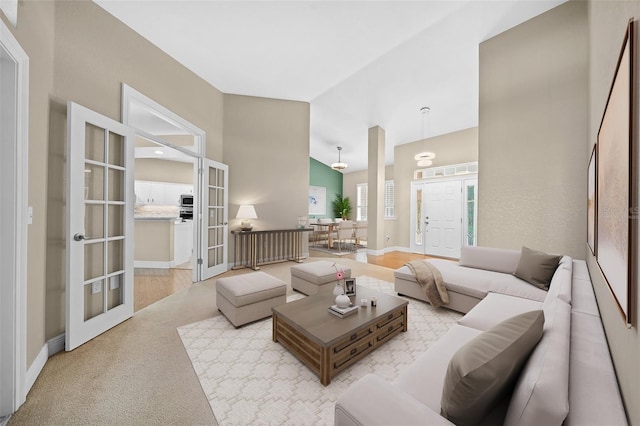 living room featuring lofted ceiling and french doors