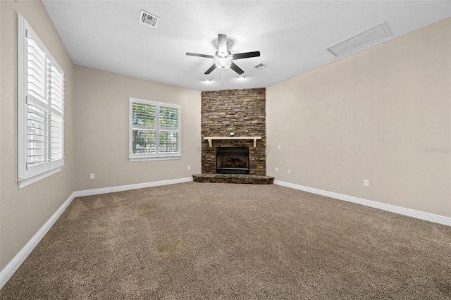 unfurnished living room with a fireplace, ceiling fan, and carpet flooring