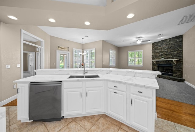 kitchen featuring pendant lighting, sink, dishwasher, an island with sink, and white cabinets