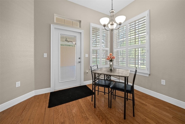 dining area with an inviting chandelier and hardwood / wood-style flooring