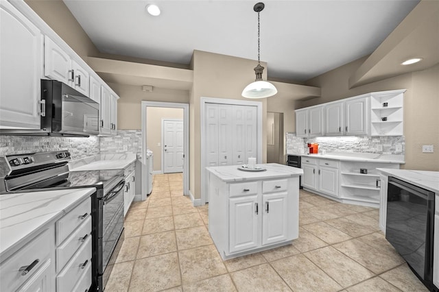 kitchen featuring white cabinetry, beverage cooler, a kitchen island, and black appliances