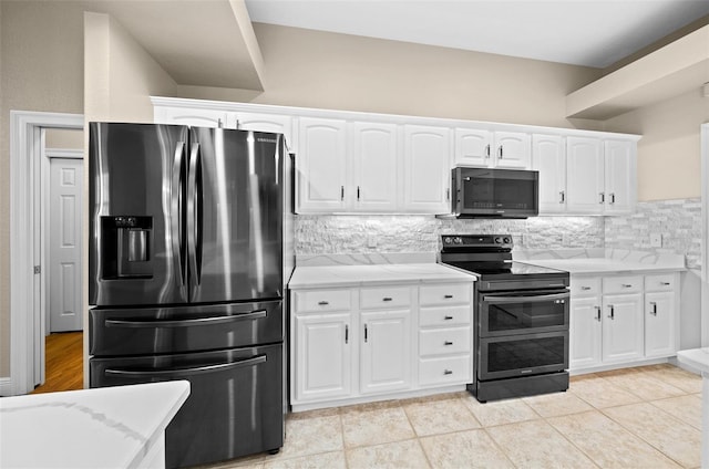 kitchen featuring stainless steel refrigerator with ice dispenser, white cabinets, and double oven range