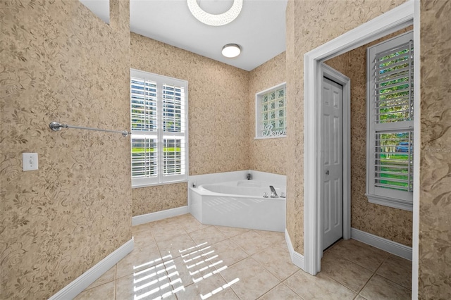 bathroom with tile patterned flooring and a washtub