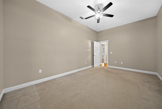 carpeted spare room featuring ceiling fan