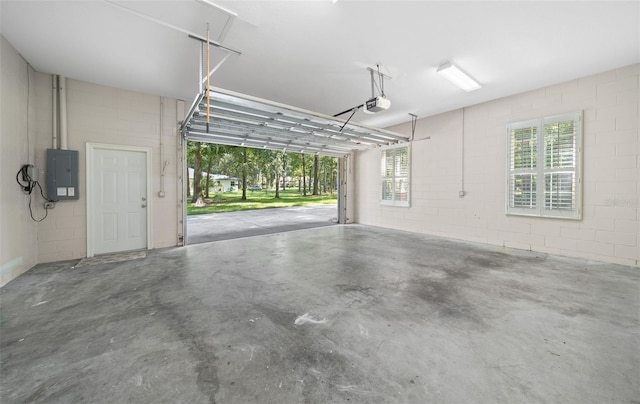 garage with a garage door opener and electric panel