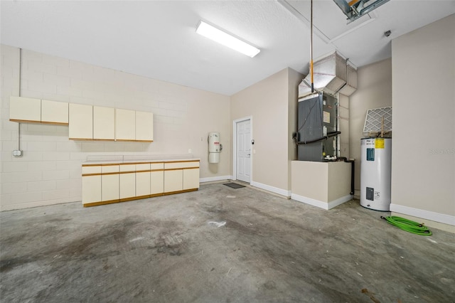 garage featuring heating unit and water heater