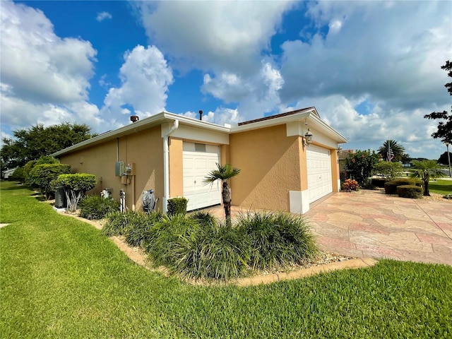 view of property exterior featuring a garage and a lawn