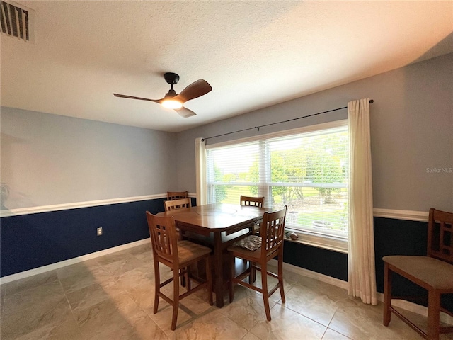 dining area with ceiling fan and light tile patterned floors