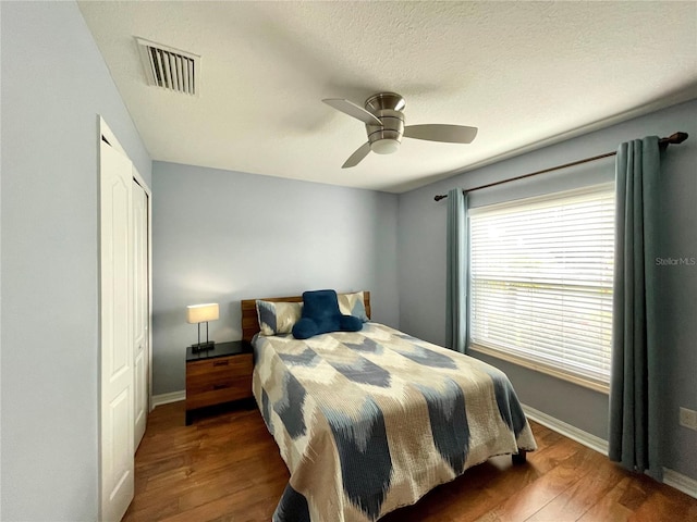 bedroom with ceiling fan, hardwood / wood-style flooring, and a closet