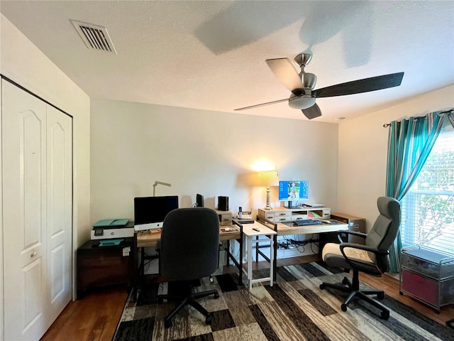 office area featuring ceiling fan, hardwood / wood-style flooring, and a textured ceiling