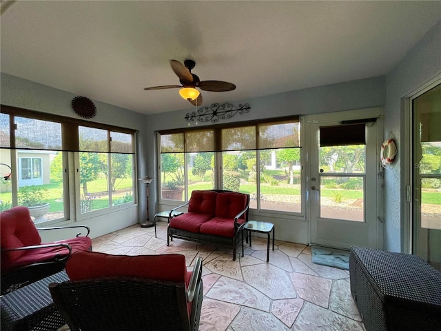 sunroom featuring ceiling fan