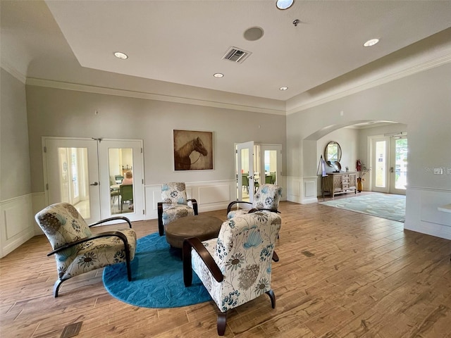 living area with french doors and light wood-type flooring