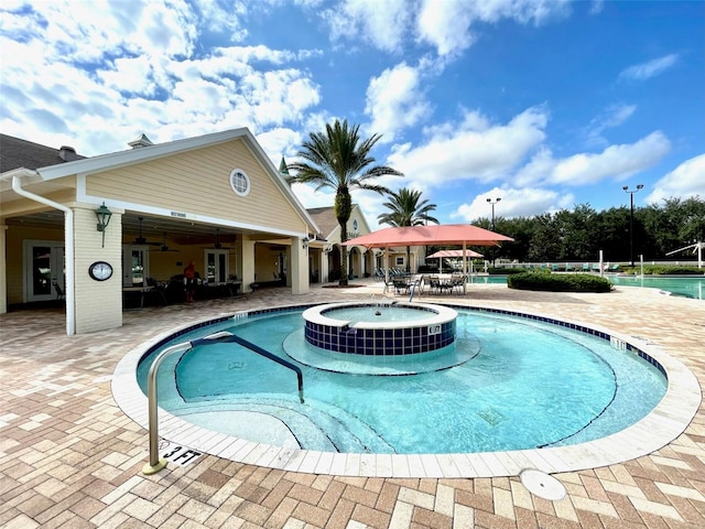 view of pool with ceiling fan, a patio, and a community hot tub