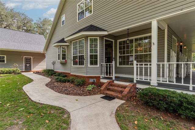 view of exterior entry with covered porch