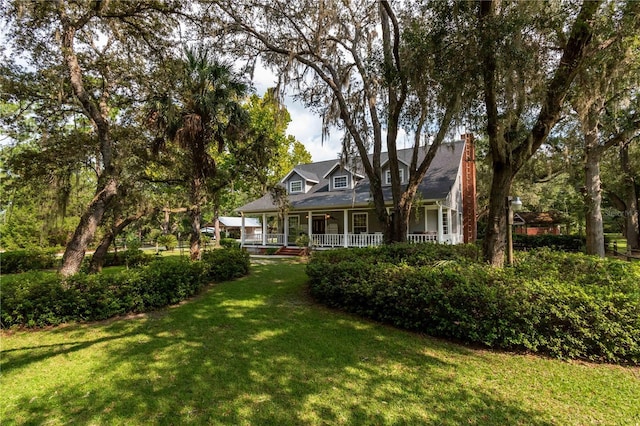 exterior space with covered porch and a yard