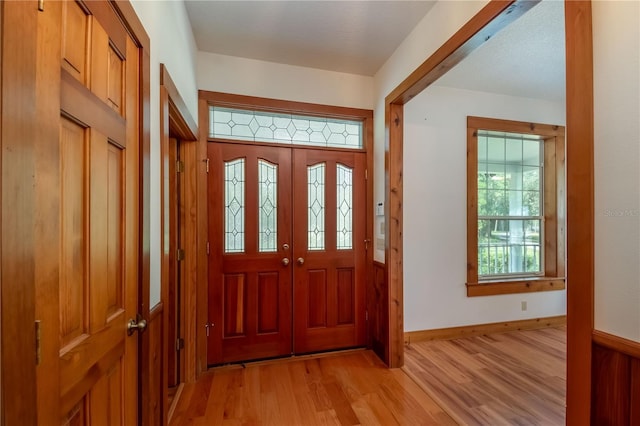 entryway featuring light wood-type flooring and baseboards