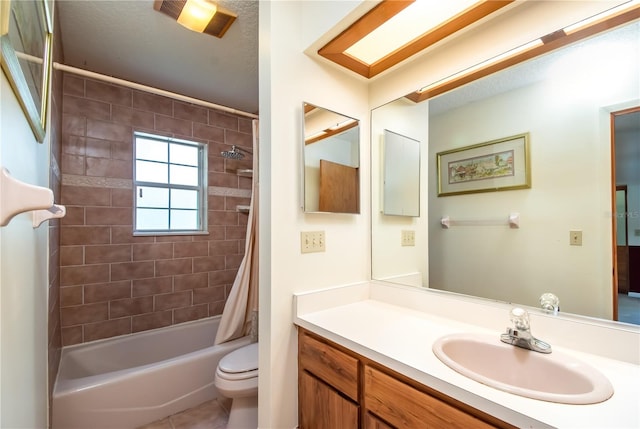 full bathroom featuring tile patterned floors, vanity, shower / tub combo, and toilet