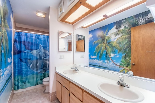 full bathroom featuring double sink vanity, toilet, shower / bath combo with shower curtain, and tile patterned floors