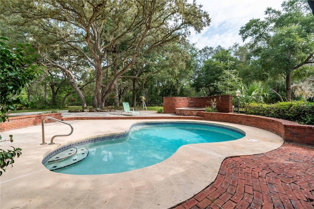 outdoor pool with a patio area