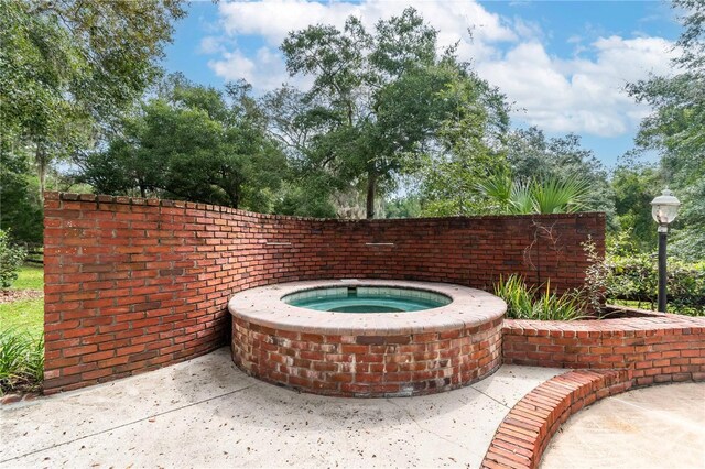 view of patio / terrace featuring an in ground hot tub