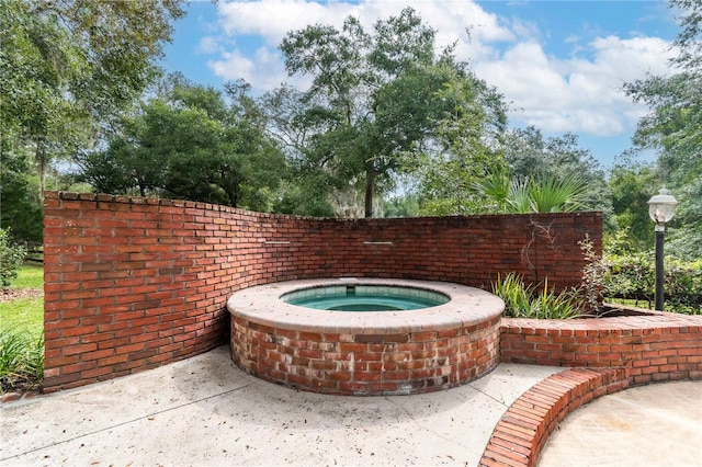 exterior space featuring an in ground hot tub