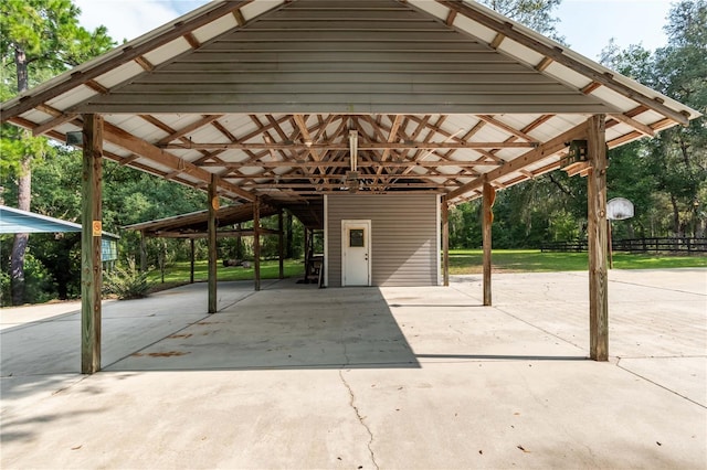 exterior space featuring a carport, concrete driveway, and fence