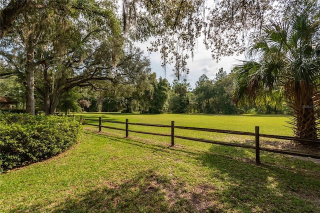 view of yard featuring a rural view and fence