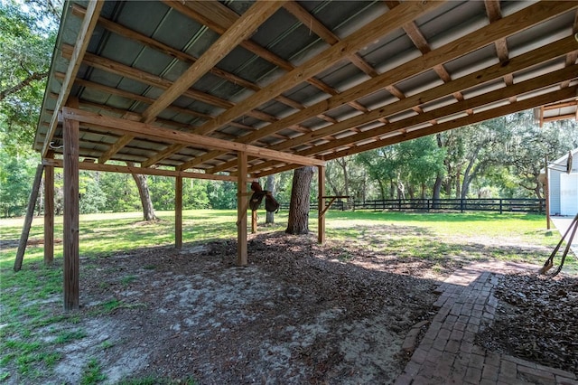 view of yard featuring a carport and fence