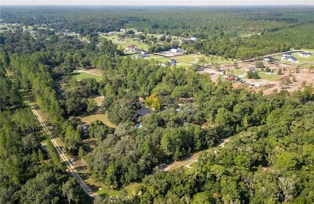 bird's eye view featuring a wooded view