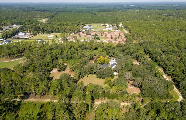 drone / aerial view with a wooded view