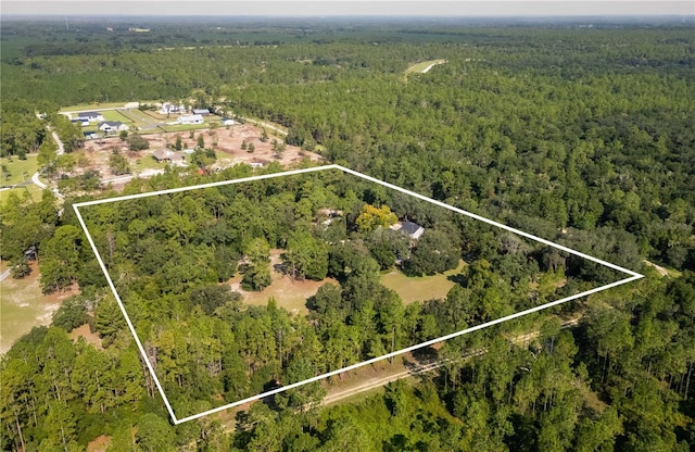 birds eye view of property featuring a wooded view