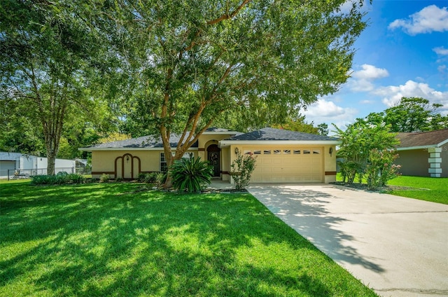 view of front of house featuring a front yard and a garage