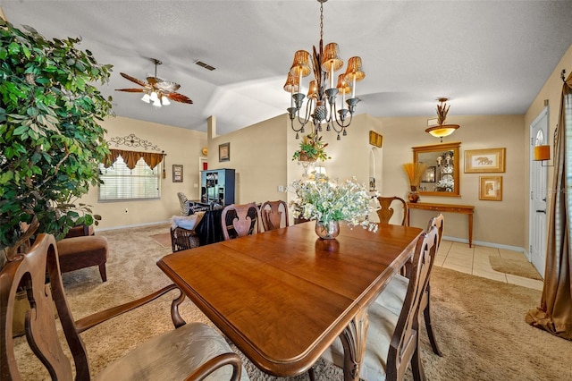 dining space with light tile patterned floors, visible vents, light colored carpet, vaulted ceiling, and ceiling fan with notable chandelier