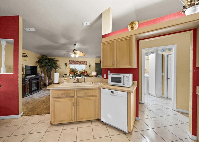 kitchen with ceiling fan, light tile patterned floors, sink, kitchen peninsula, and white appliances