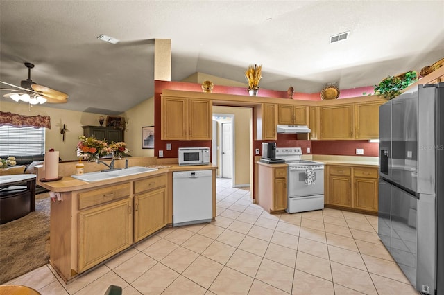 kitchen featuring ceiling fan, vaulted ceiling, light tile patterned floors, sink, and white appliances