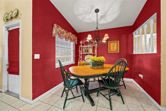 dining space with light tile patterned floors, lofted ceiling, an inviting chandelier, an accent wall, and baseboards