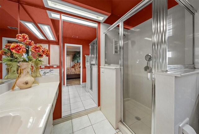 bathroom with an enclosed shower, tile patterned floors, and vanity