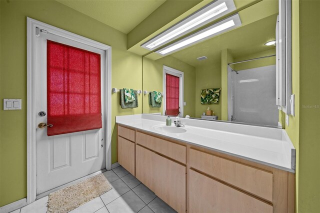 bathroom with tile patterned flooring and vanity