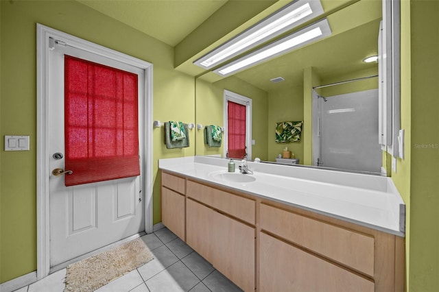 full bathroom with a shower, tile patterned flooring, vanity, and toilet