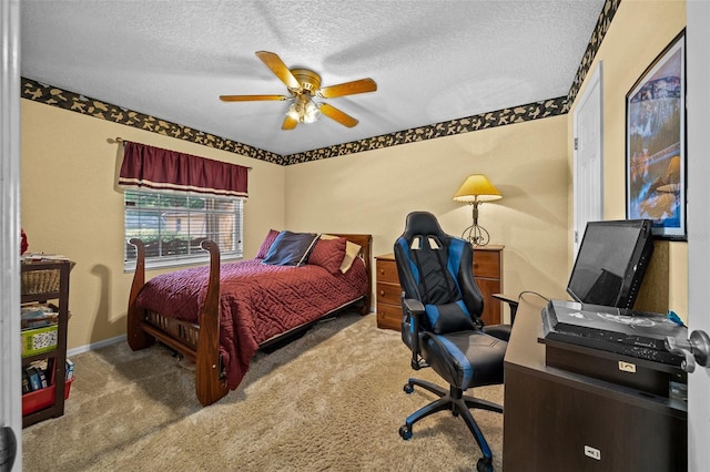 bedroom with ceiling fan, a textured ceiling, and carpet flooring